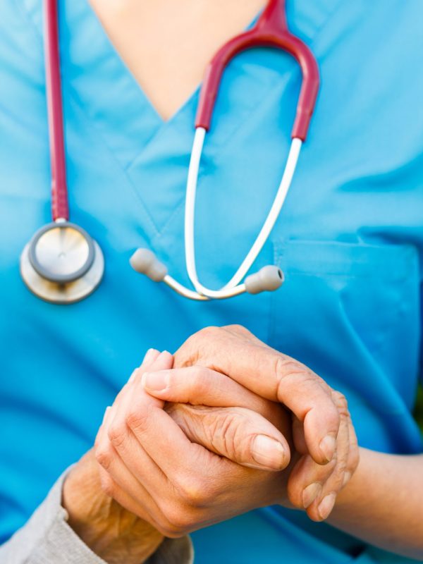 Close-up,Of,And,Old,Hand,Being,Supported,By,A,Doctor.