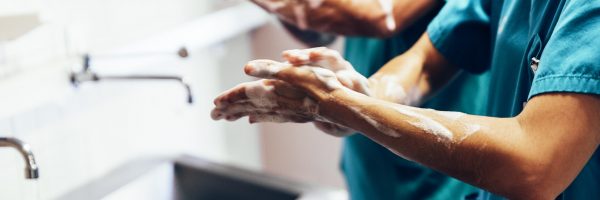 Couple,Of,Surgeons,Washing,Hands,Before,Operating.,Hospital,Concept.
