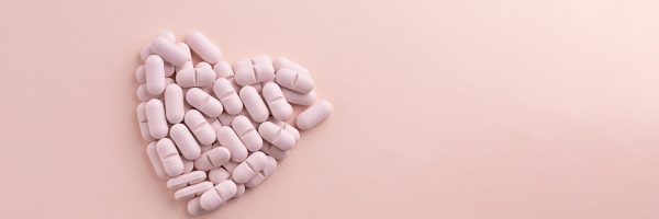 Heart,Made,Of,Pills,On,Pink,Background.,Creative,Concept,For