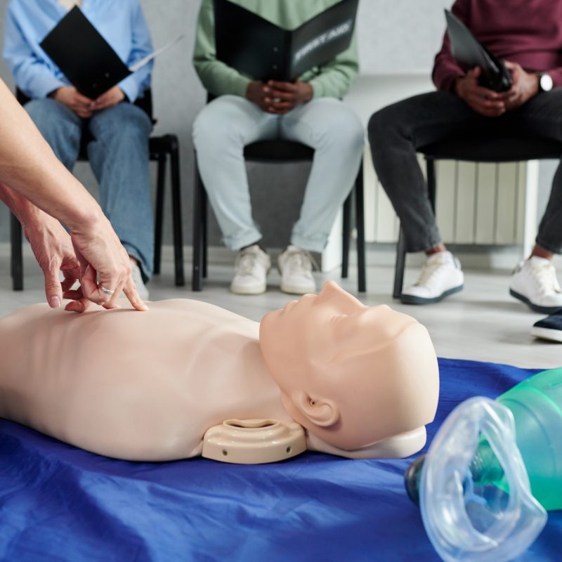 Instructor teaching first aid cardiopulmonary resuscitation course